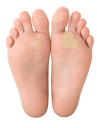Two feet with Duct Tape Methiod adhesive patches on a white background